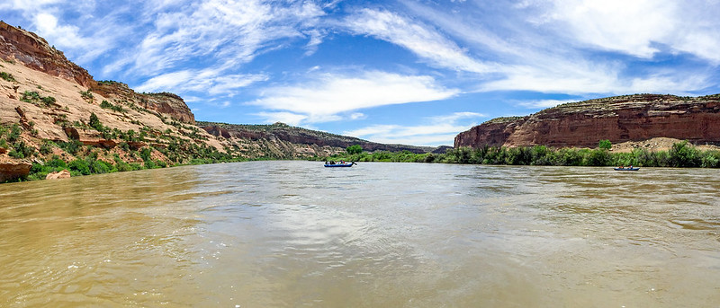A group of people in boats rafting down the Colorado River in Fruita, Colorado