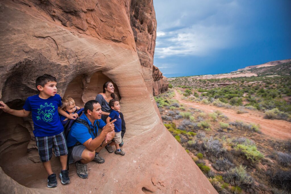 Family sitting in a large rock in Fruita