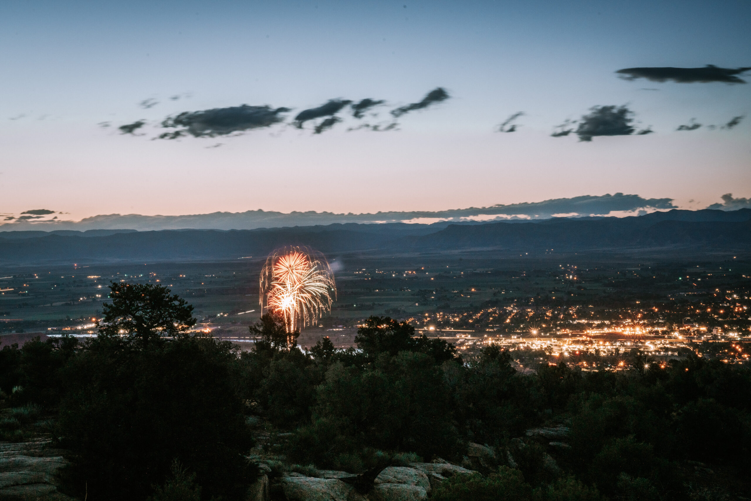 A fireworks show seen from above at the Colorado National Monument.