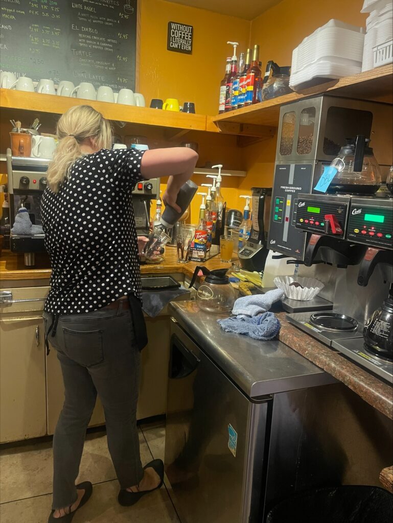 The owner of Camilla's Kaffe making a frozen drink. 