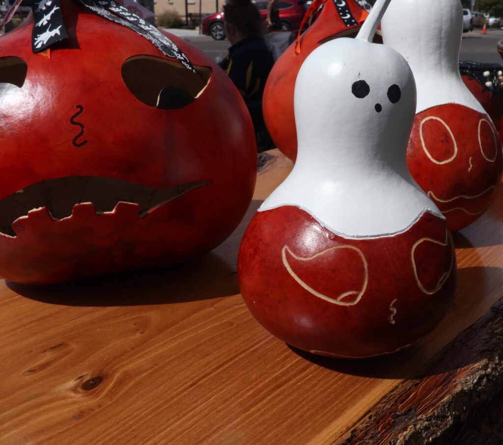 Gourds and pumpkins carved to look like ghosts.