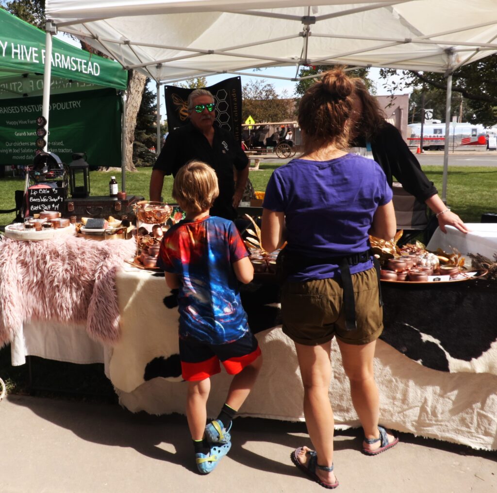 A mom and son look at baked goods.