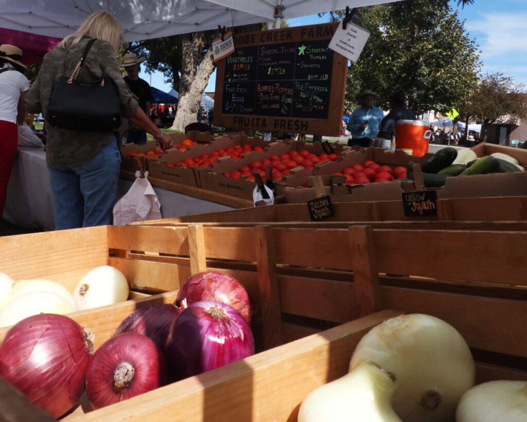 People shop for vegetables at a local stand.