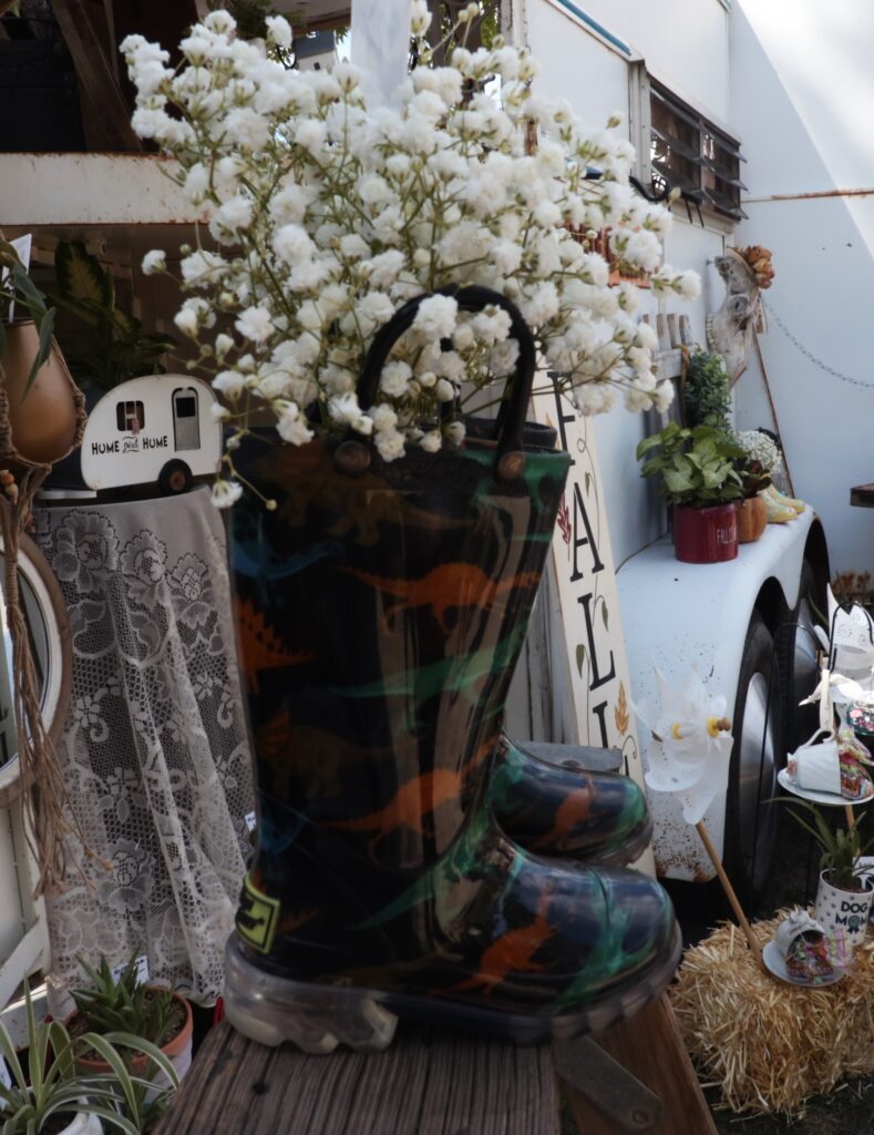 A bundle of flowers in a rain boot. 