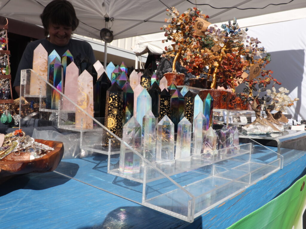 A woman sells crystals.