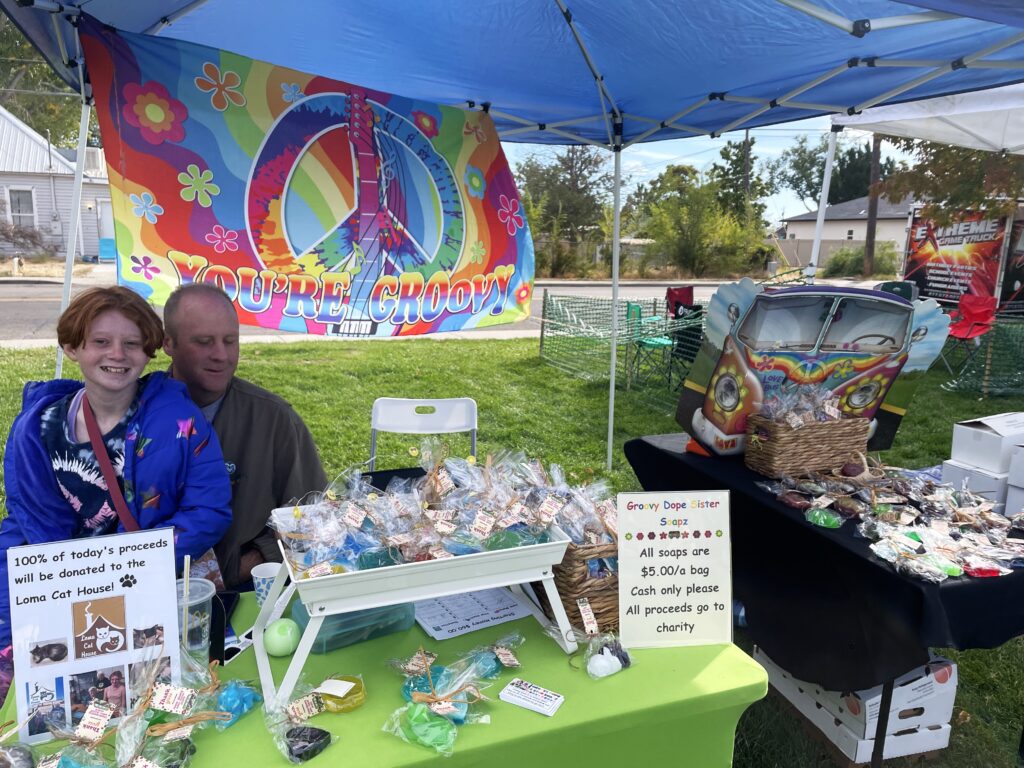 A dad and his daughter sell homemade soap at the Fruita Farmers Market.