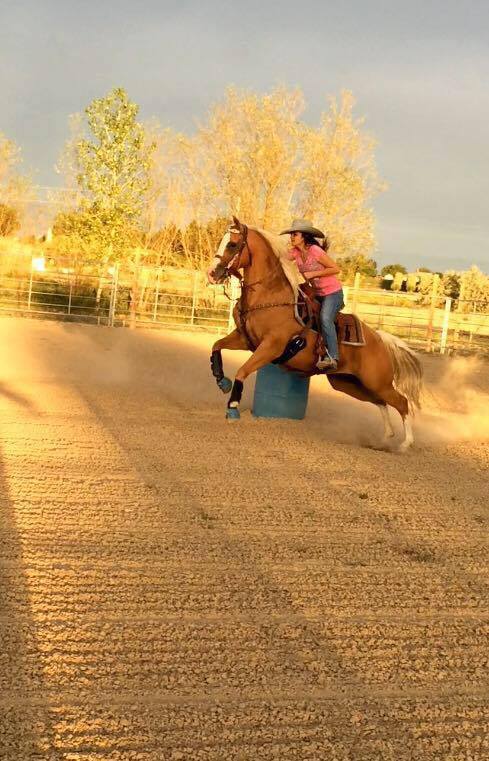 A woman barrel races at the Fruita Rimrock Rodeo.