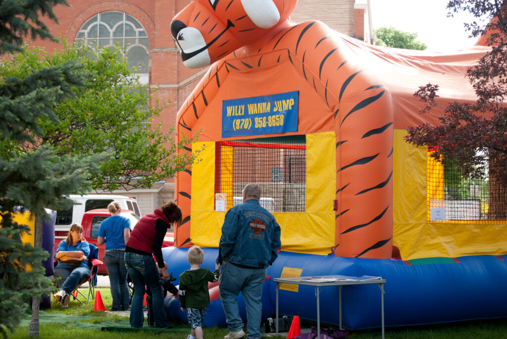 A bouncy house made to look like a tiger with people getting on.