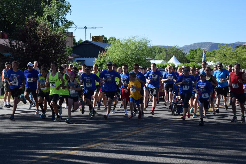 A large group of people begin to run a race.