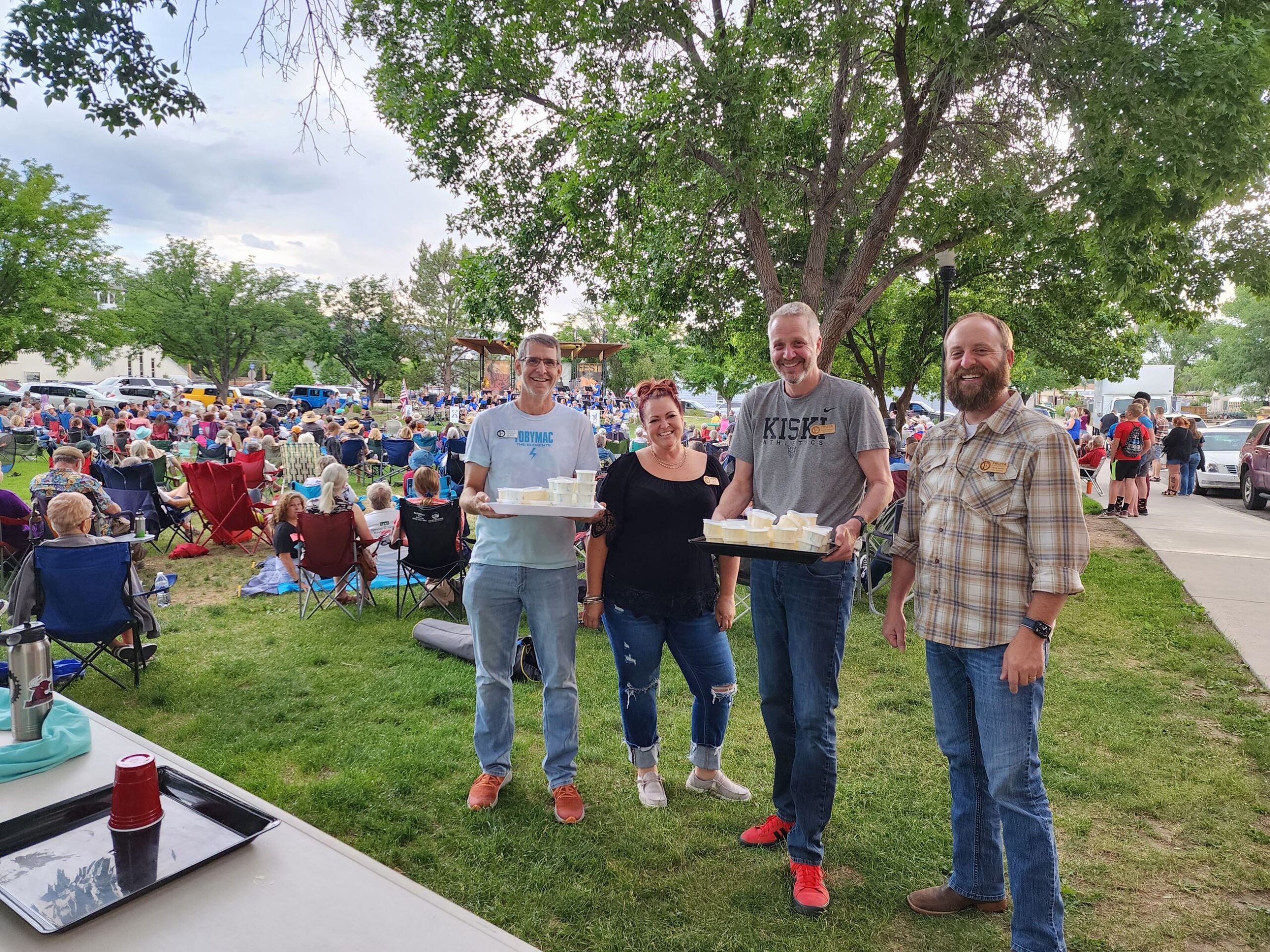 Four City Council members with two trays of ice cream cups.