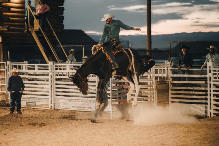 A man riding a horse at a rodeo